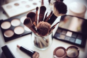 make up brushes in a glass