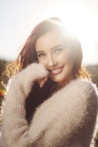 Smiling woman sunflare